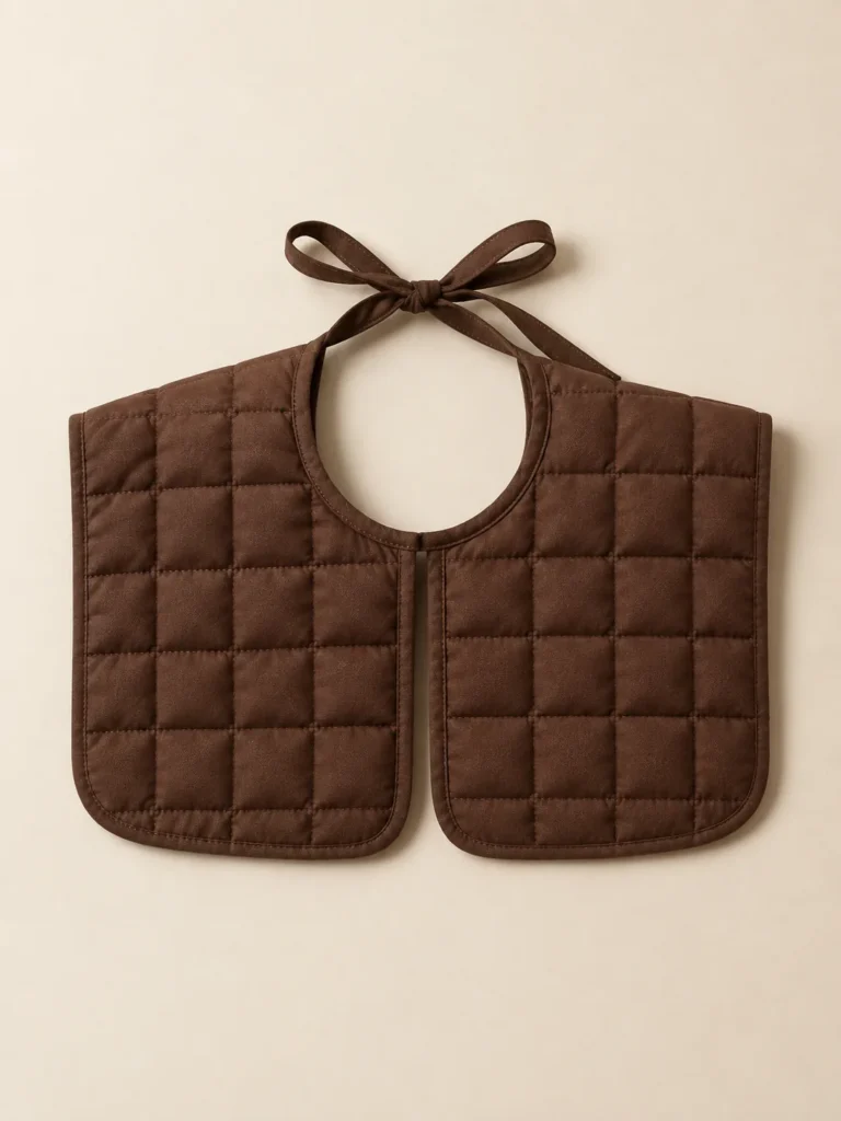 Bib Grid Collar in Cocoa, front view on a cream plinth