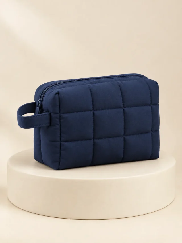 Boxy Wash Pouch in Ink Navy, front view on a cream plinth
