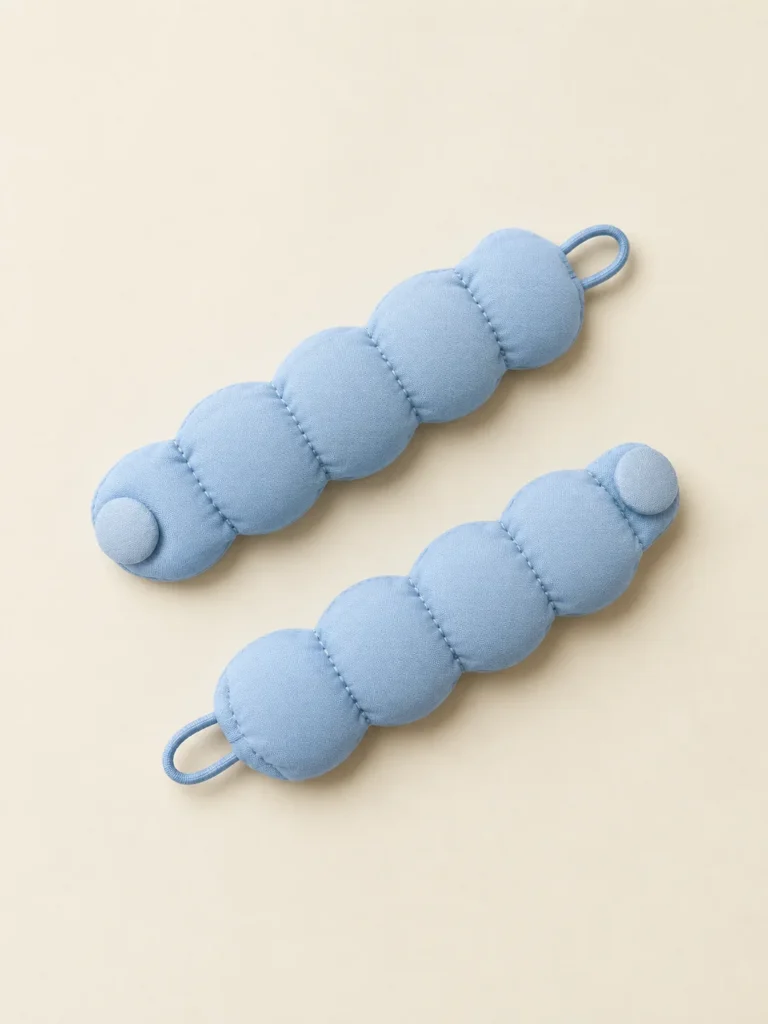 Bubble Cuff Pair in Powder Blue, front view on a cream plinth