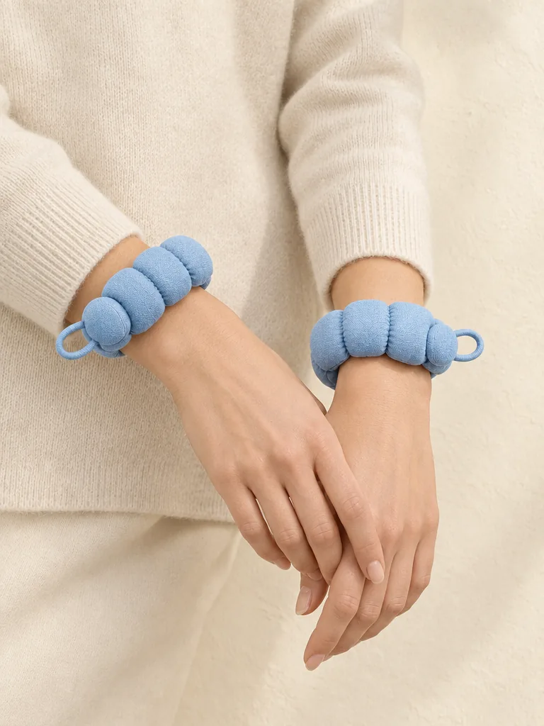 Bubble Cuff Pair in Powder Blue, shown worn or carried to show its size