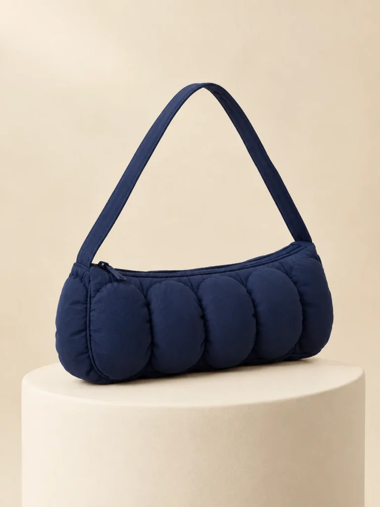 Bubble Row Baguette in Ink Navy, front view on a cream plinth