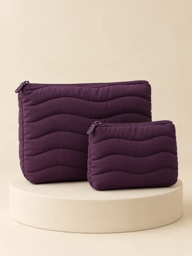 Duo Nest Pouch Set in Plum, front view on a cream plinth