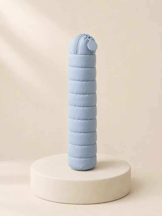 Pillow Pen Pouch in Powder Blue, front view on a cream plinth