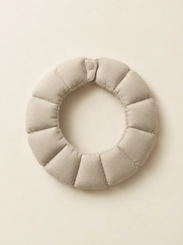 Ruff Ring Collar in Oat, front view on a cream plinth
