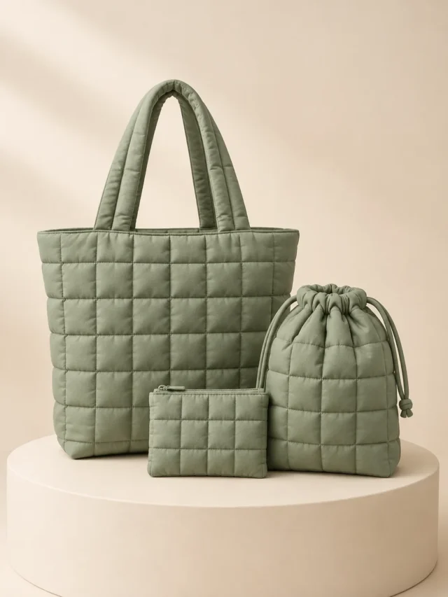 Weekend Carry Trio in Sage, front view on a cream plinth